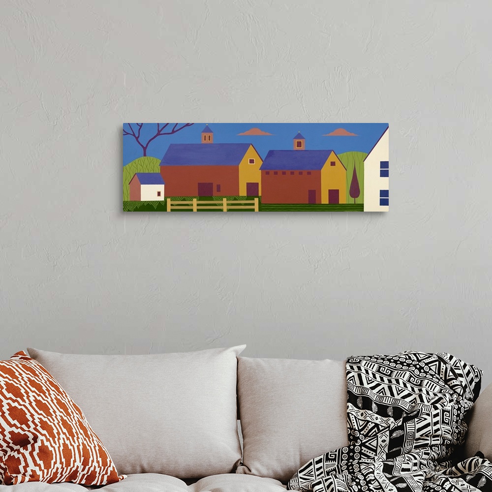 A bohemian room featuring Oversized, horizontal folk art on a wall hanging of simplistically shaped buildings in a group, s...