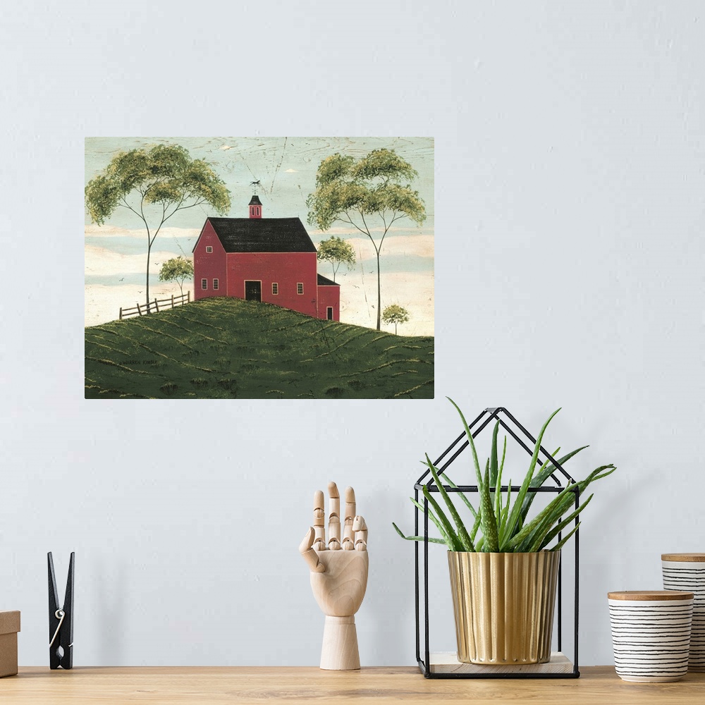 A bohemian room featuring A large barn is painted sitting on a hill and surrounded by two very tall trees and some smaller.
