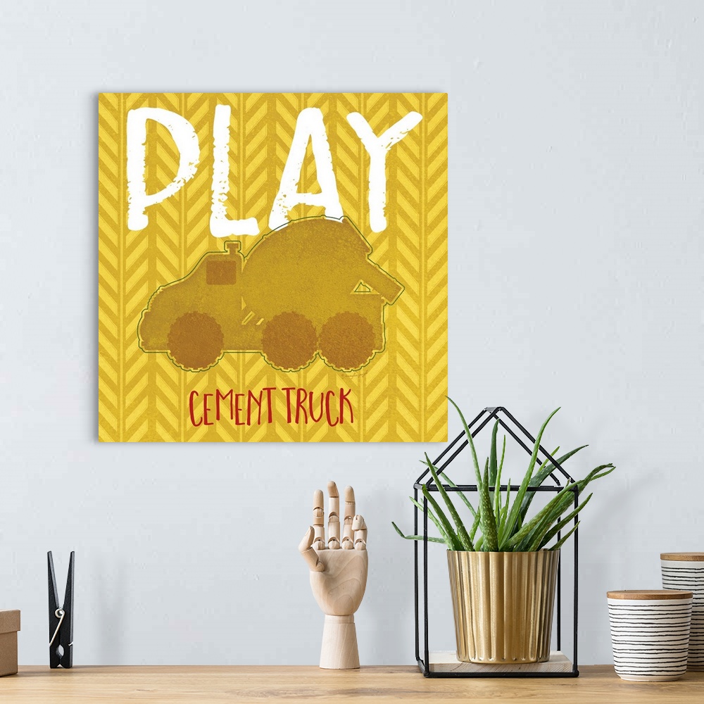 A bohemian room featuring Children's artwork of a construction cement truck with the word, "Play" above.