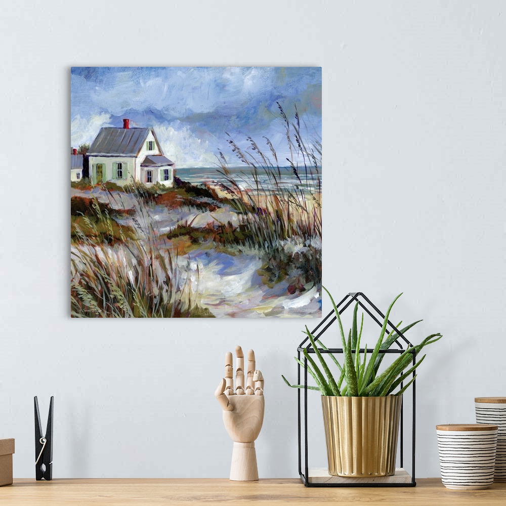 A bohemian room featuring A coastal cottage sits among the dunes and water's edge.