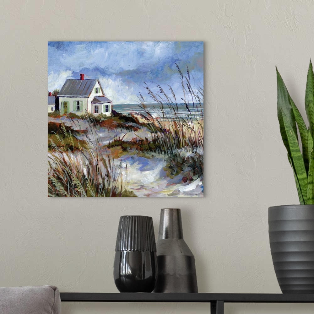 A modern room featuring A coastal cottage sits among the dunes and water's edge.