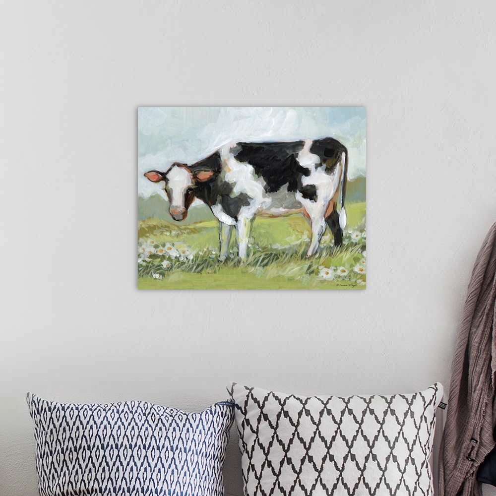 A bohemian room featuring A black & white cow enjoys his pastoral setting!