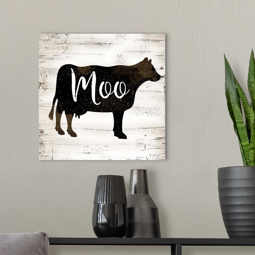 A modern room featuring Graphic art of the silhouette of a cow with script text overlapping it, on a a horizontally strip...