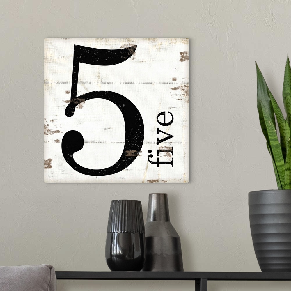 A modern room featuring Graphic art with the number five bold and large in the center, and the word five written smaller,...