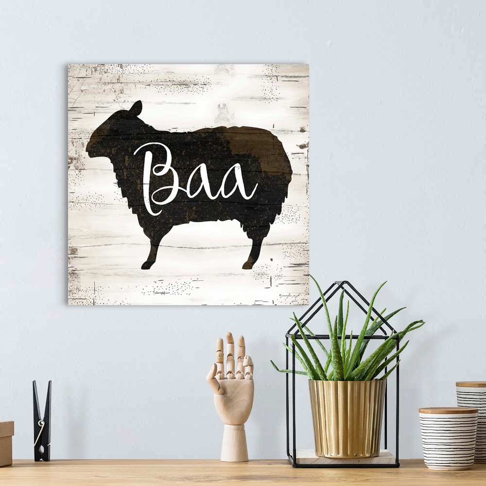 A bohemian room featuring Rustic art of the silhouette of a sheep with script text over it, on a background with an old woo...