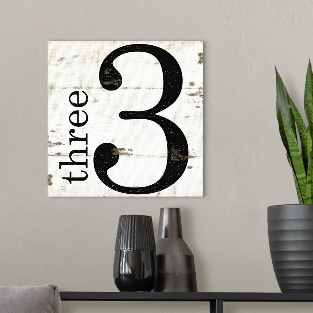 A modern room featuring Graphic art with the number three bold and large in the center, and the word three written smalle...