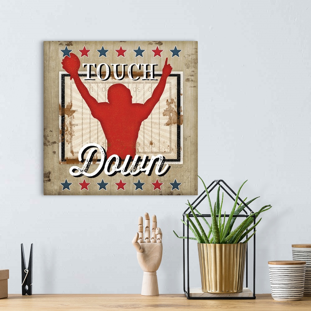 A bohemian room featuring Distressed themed artwork of football with the word, "Touchdown" .