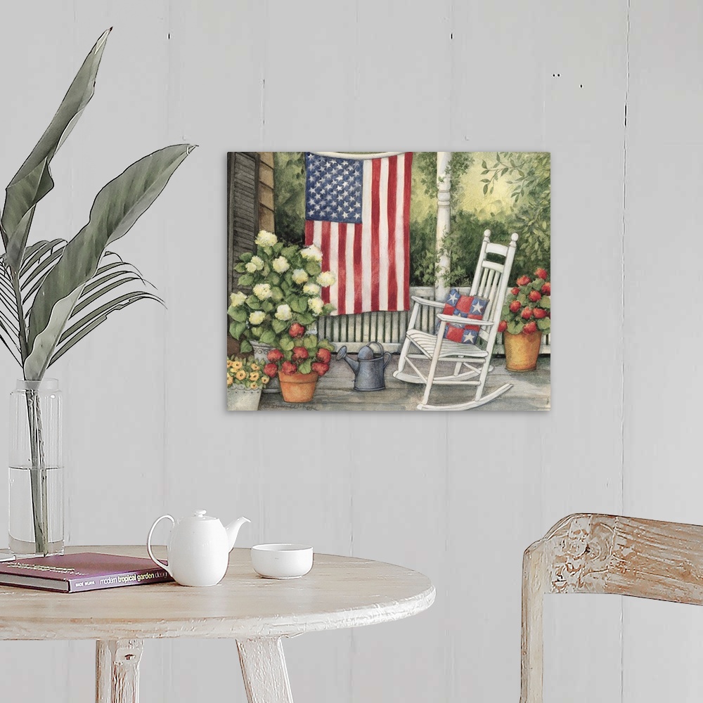 A farmhouse room featuring Front porch setting with white rocking chair, flowers and big american flag.