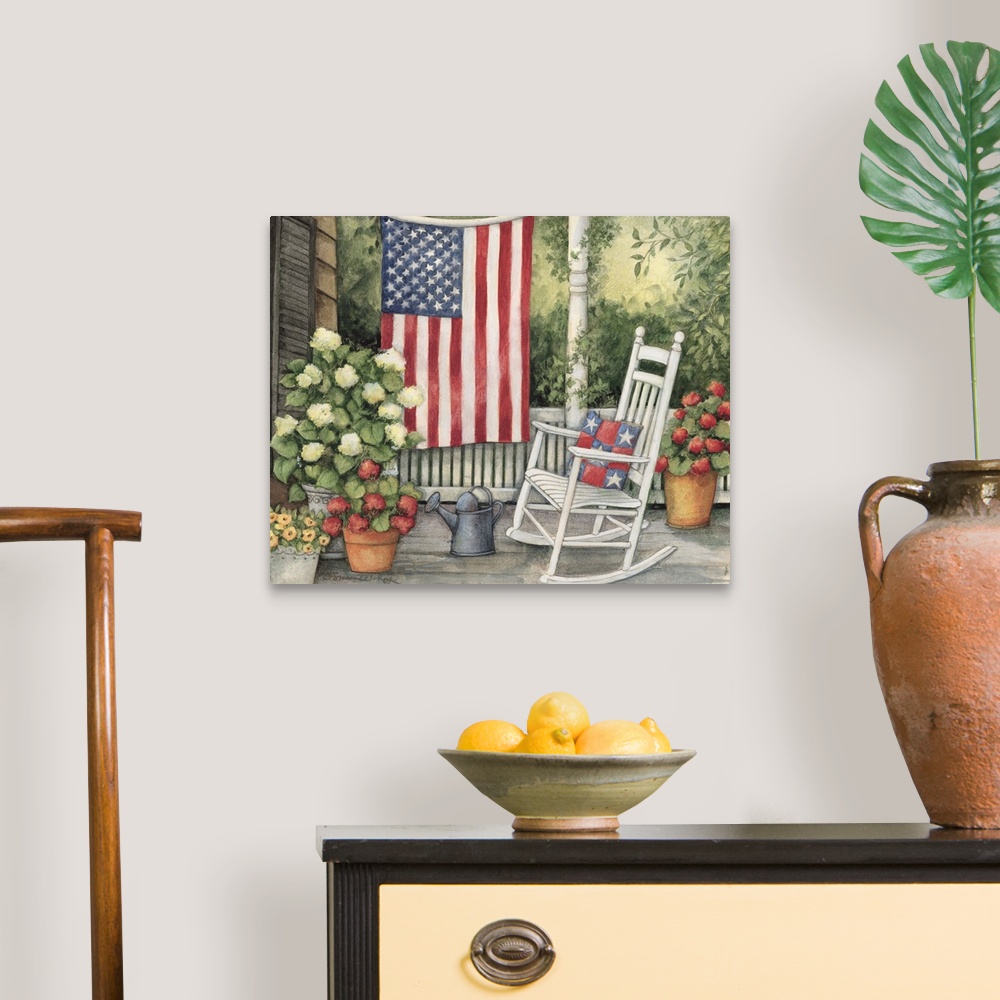 A traditional room featuring Front porch setting with white rocking chair, flowers and big american flag.