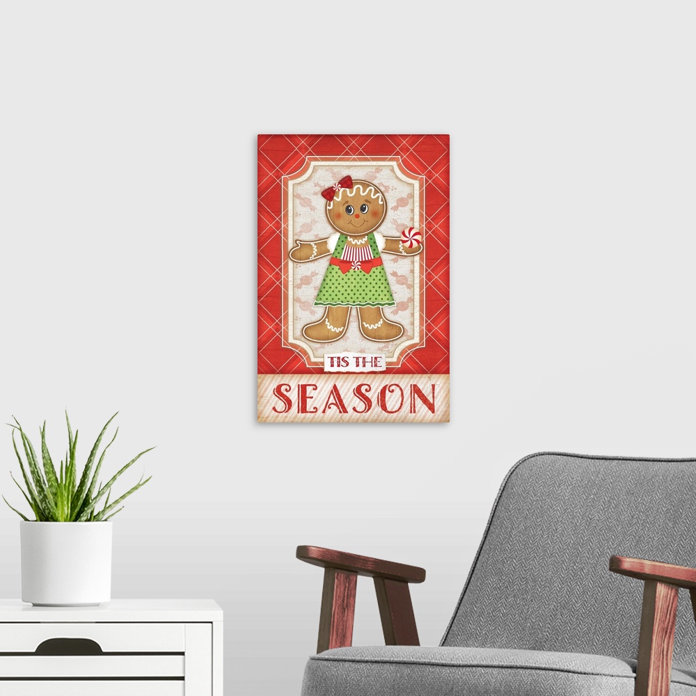 A modern room featuring Holiday themed home decor artwork of a gingerbread girl against a red and white plaid background.