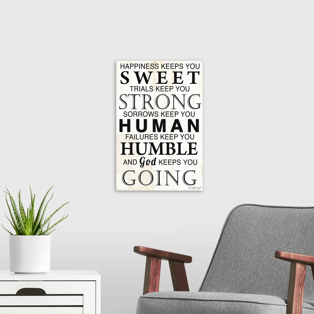 A modern room featuring Oversized vertical wall art of text reading ""happiness keeps you sweet, trials keep you strong, ...