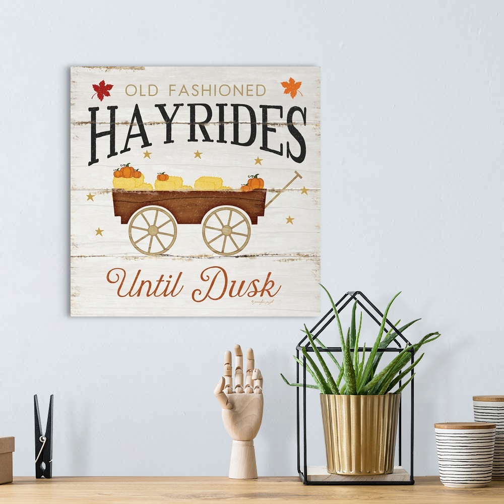 A bohemian room featuring Rustic fall themed decor with the words, "Old fashioned hayrides until dusk" .