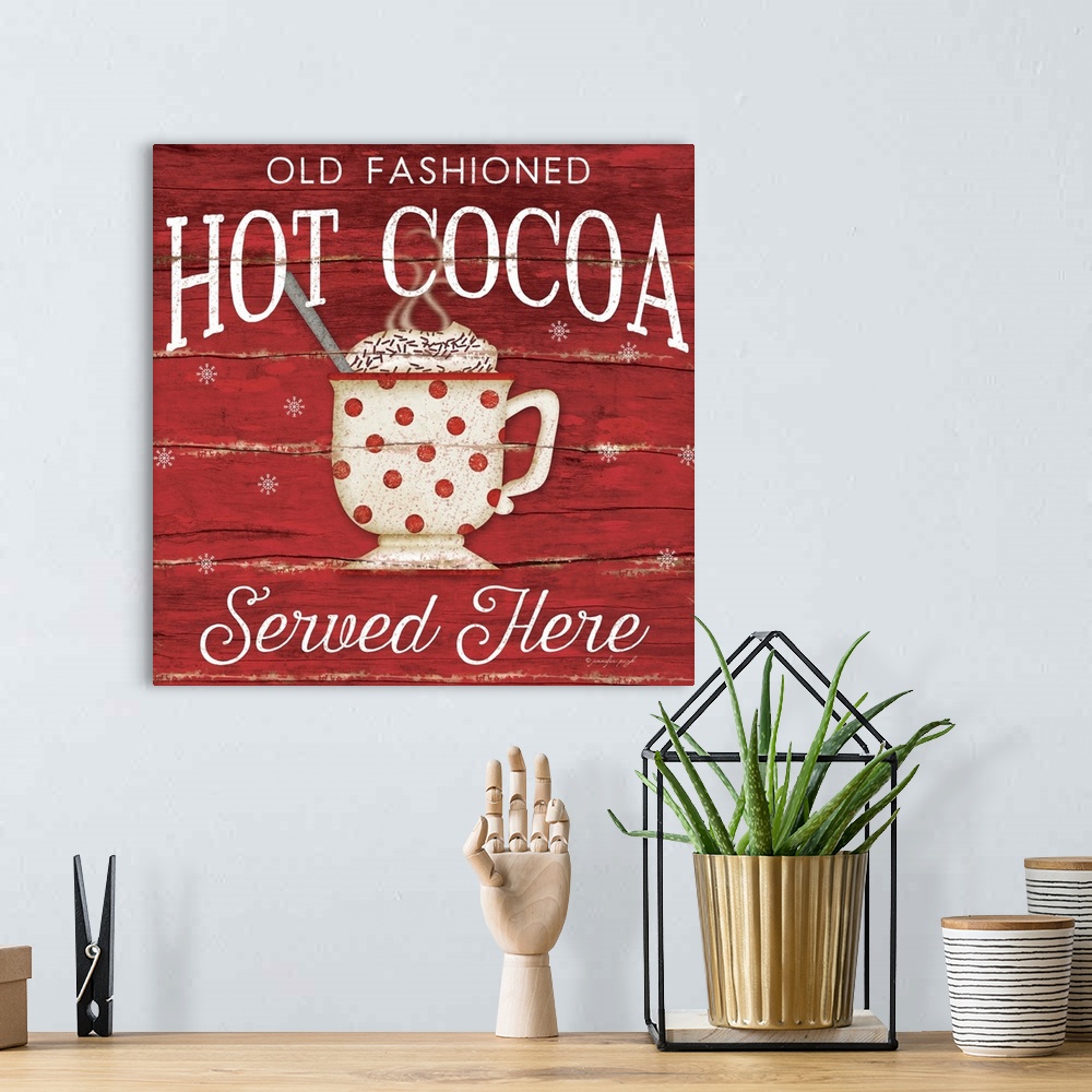 A bohemian room featuring Christmas themed typography artwork in festive seasonal colors.