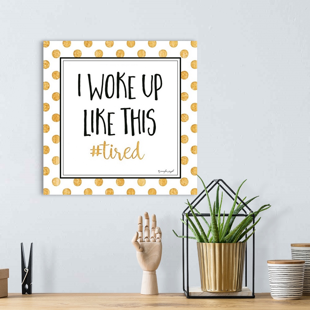 A bohemian room featuring Graphic art with text in a framed square, on a white background with golden polka dots.