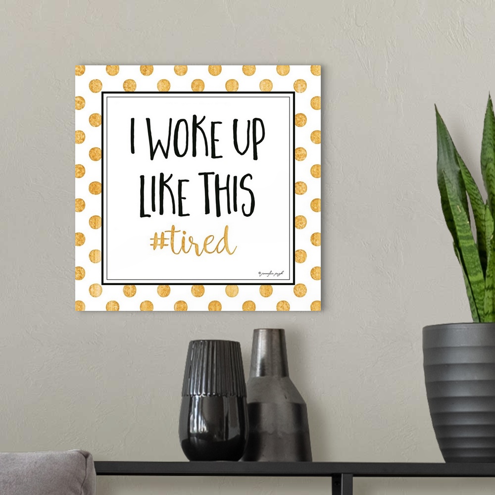 A modern room featuring Graphic art with text in a framed square, on a white background with golden polka dots.