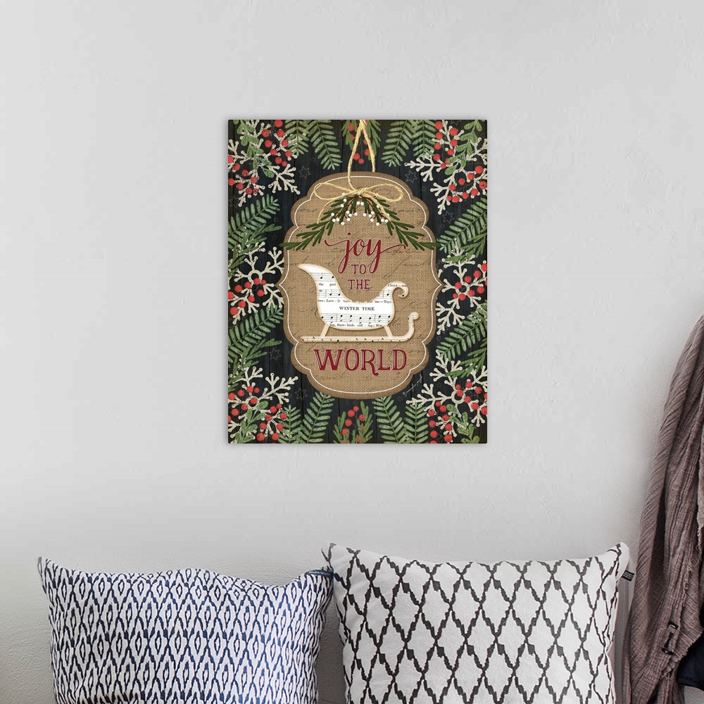 A bohemian room featuring Christmas decor featuring a sled cut out of sheets of music and the words, "Joy to the world" .