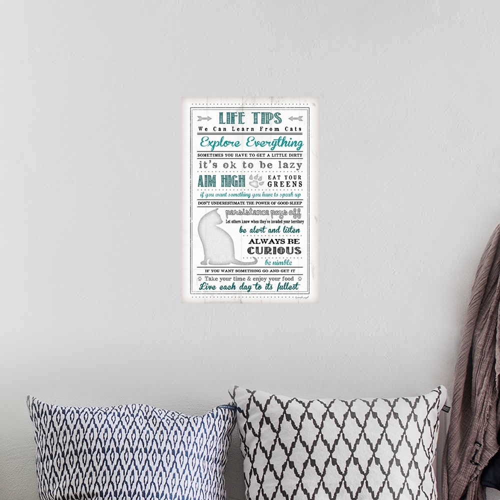 A bohemian room featuring Written out life tips that we can learn from cats in blue, grey, and black.