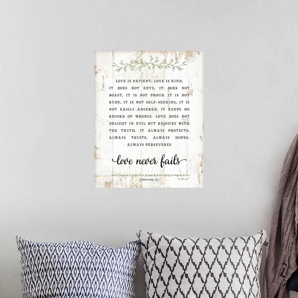 A bohemian room featuring The verse, 1 Corinthians 13:4, is black text on a distressed white background that is concluded w...
