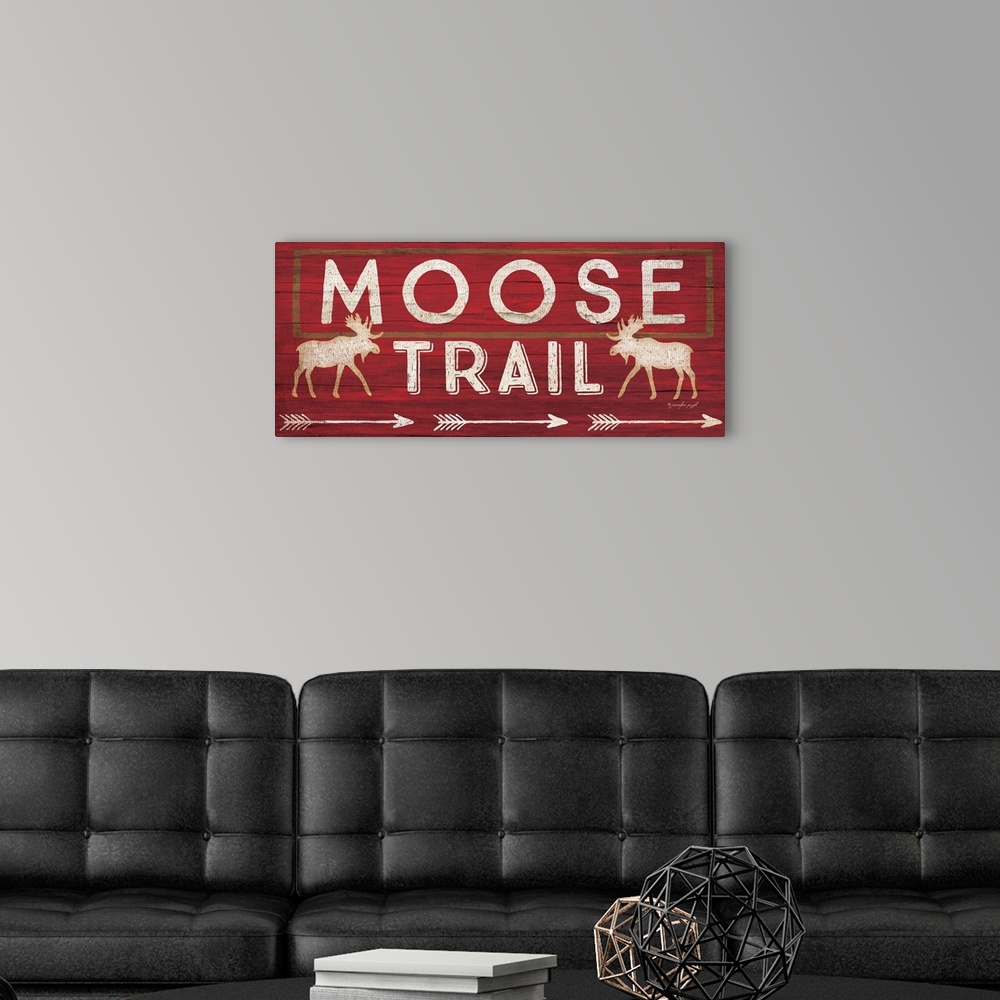 A modern room featuring Contemporary cabin decor artwork of a wooden sign for Moose Trail.