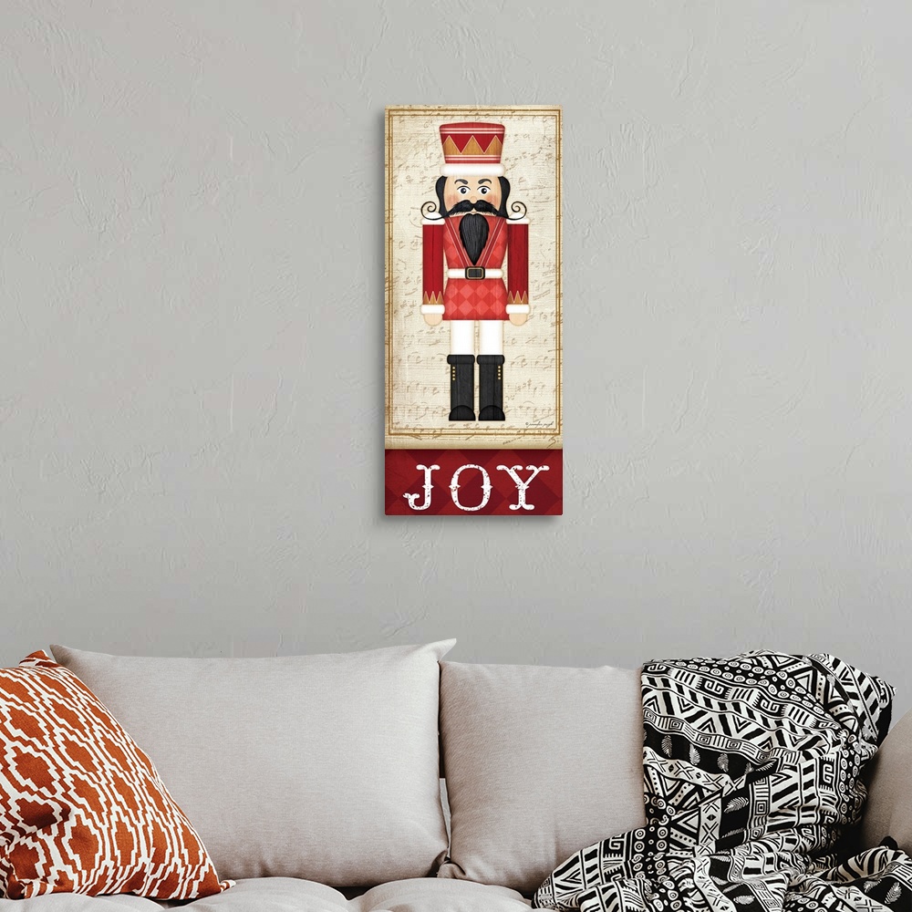 A bohemian room featuring Holiday themed home decor artwork of a nutcracker wearing a red tunic above the word Joy.