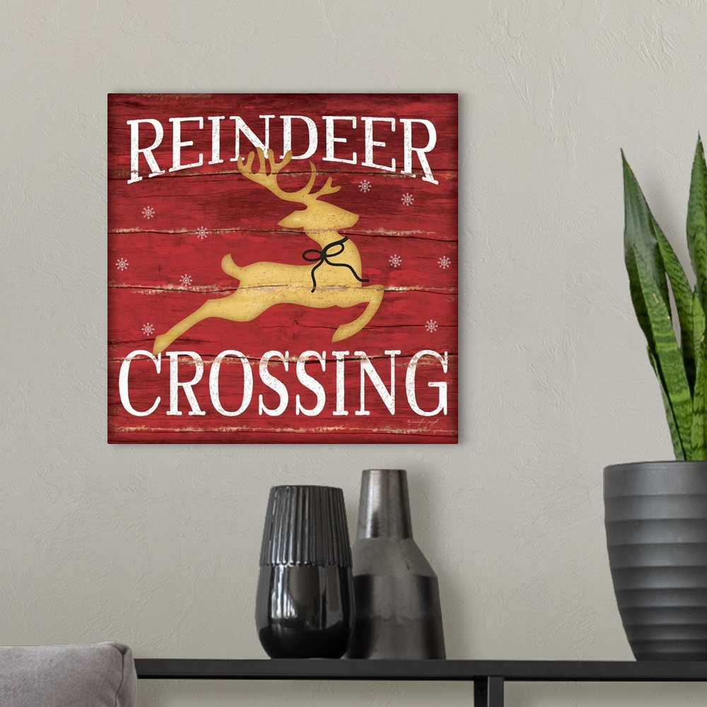 A modern room featuring Christmas themed typography artwork in festive seasonal colors.