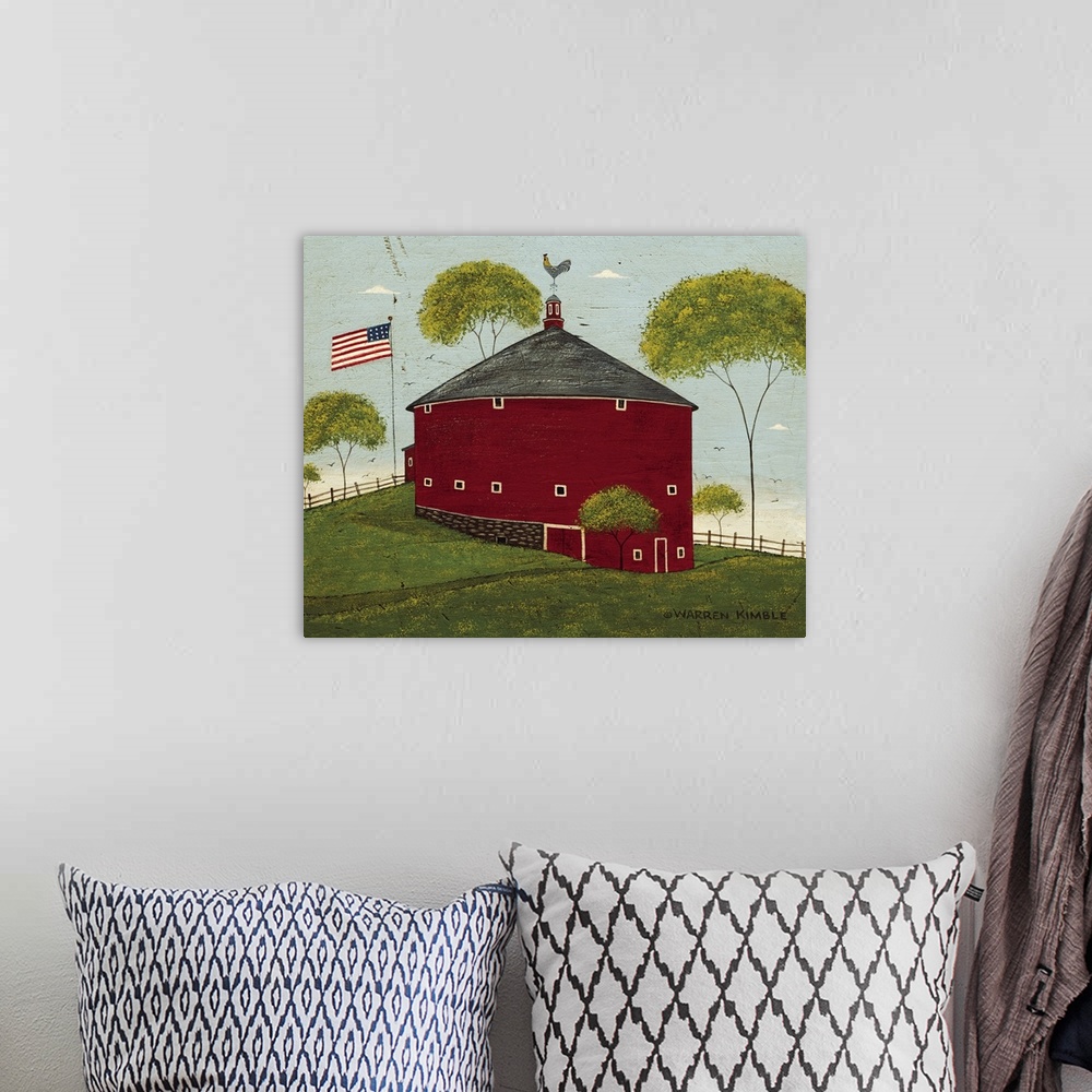 A bohemian room featuring Horizontal, folk art painting on a big wall hanging of a red, round barn on a hillside, surrounde...
