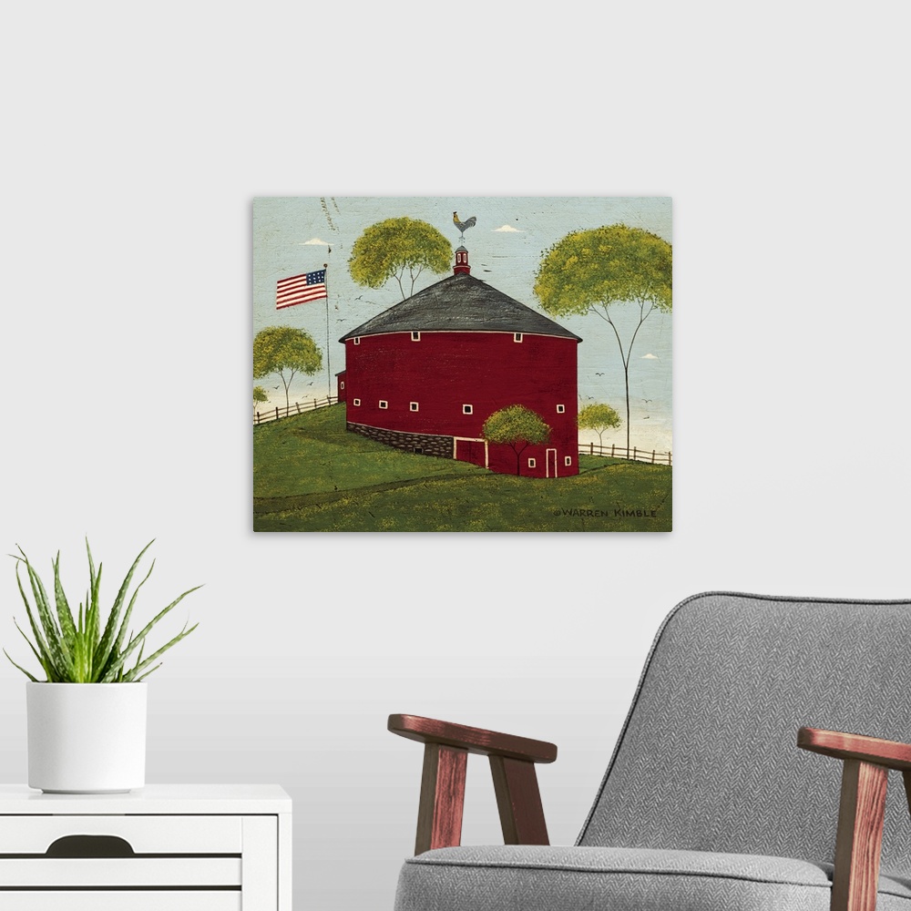 A modern room featuring Horizontal, folk art painting on a big wall hanging of a red, round barn on a hillside, surrounde...