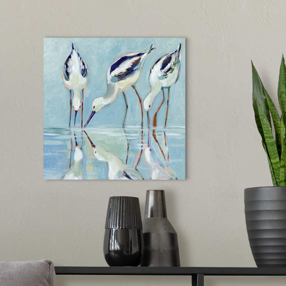 A modern room featuring A stately and elegant of stilt birds linger at water's edge.