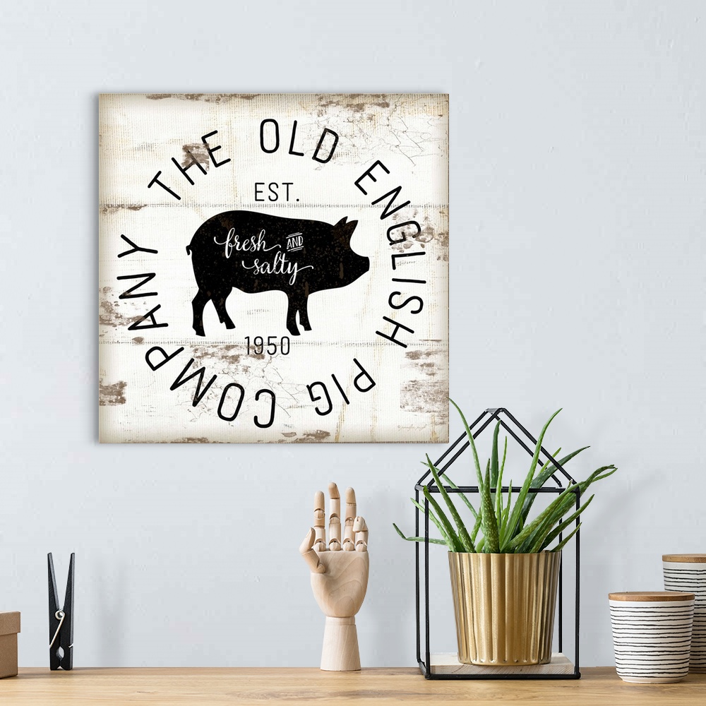 A bohemian room featuring A digital illustration of "The Old Pig Company" on a white shiplap background.