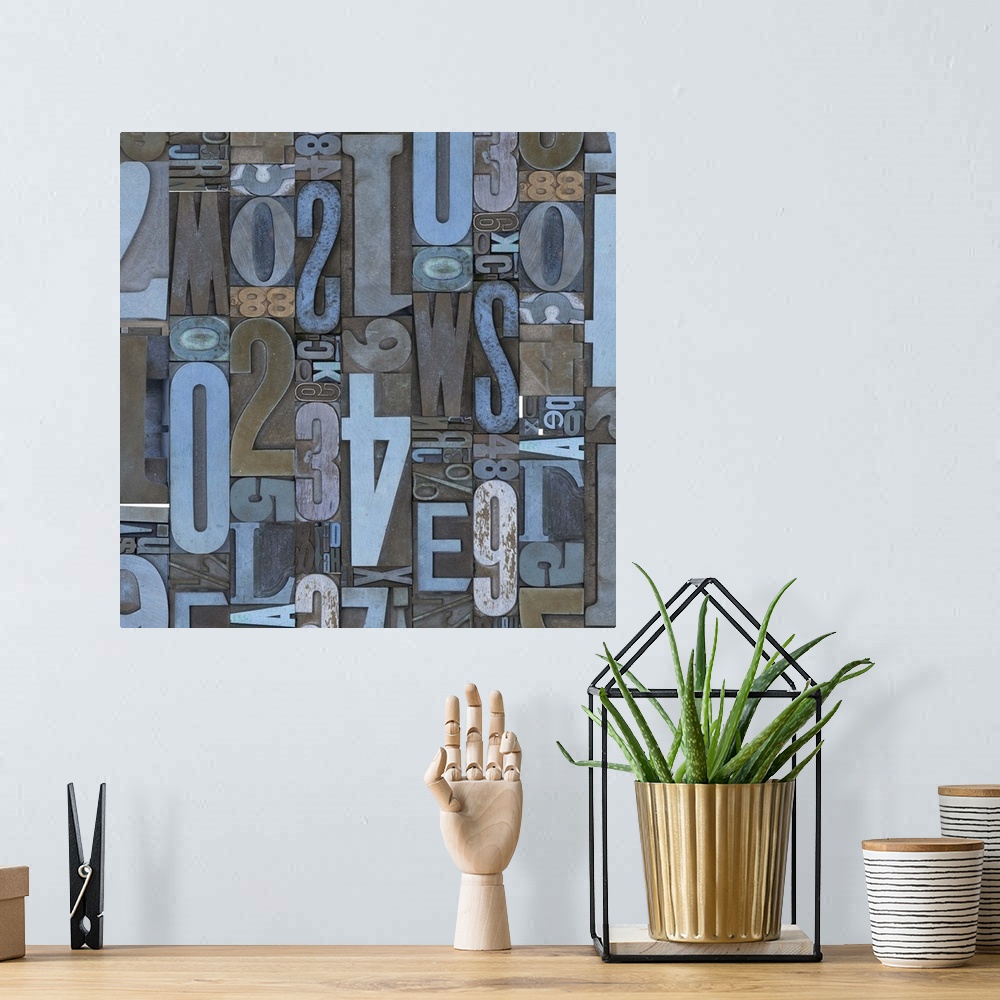 A bohemian room featuring Abstract canvas print of random numbers and letters arranged together in varying directions and s...