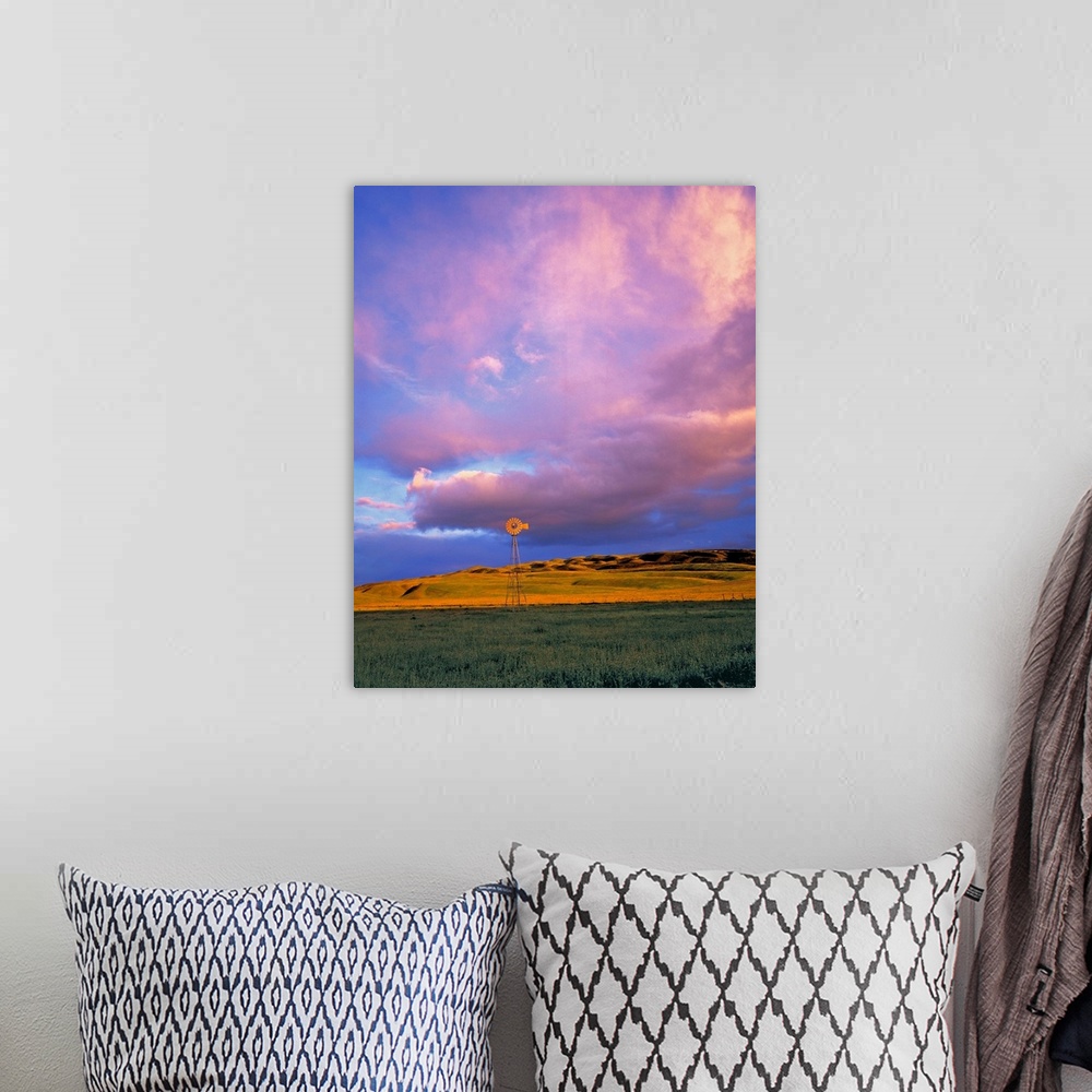 A bohemian room featuring A windmill is dwarfed by enormous violet clouds in Ventura County, California.