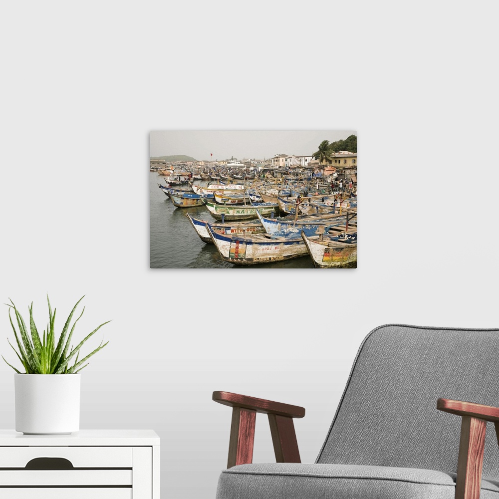 A modern room featuring Africa, West Africa, Ghana, Elmina. Colorful hand-painted fishing boats tied up at Elmina port.