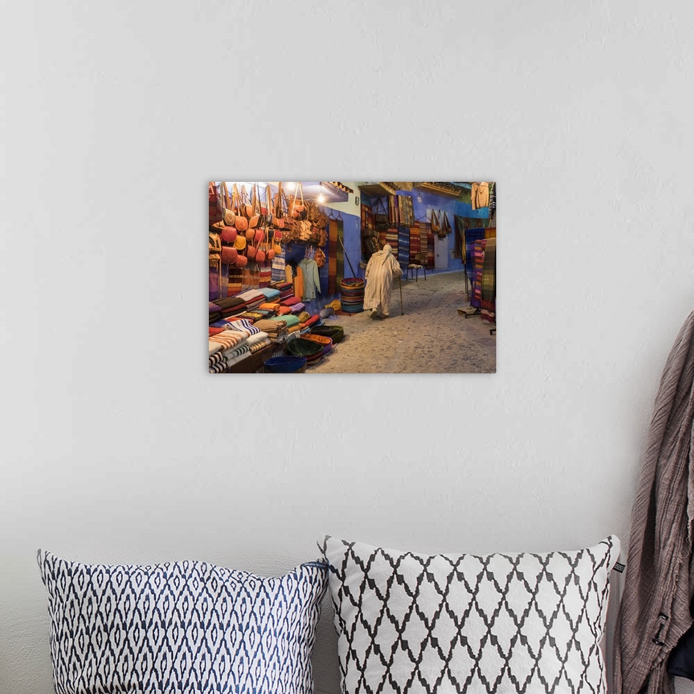 A bohemian room featuring Africa, Morocco. An elderly man walks past tourist shops along a street in the blue city of Chefc...