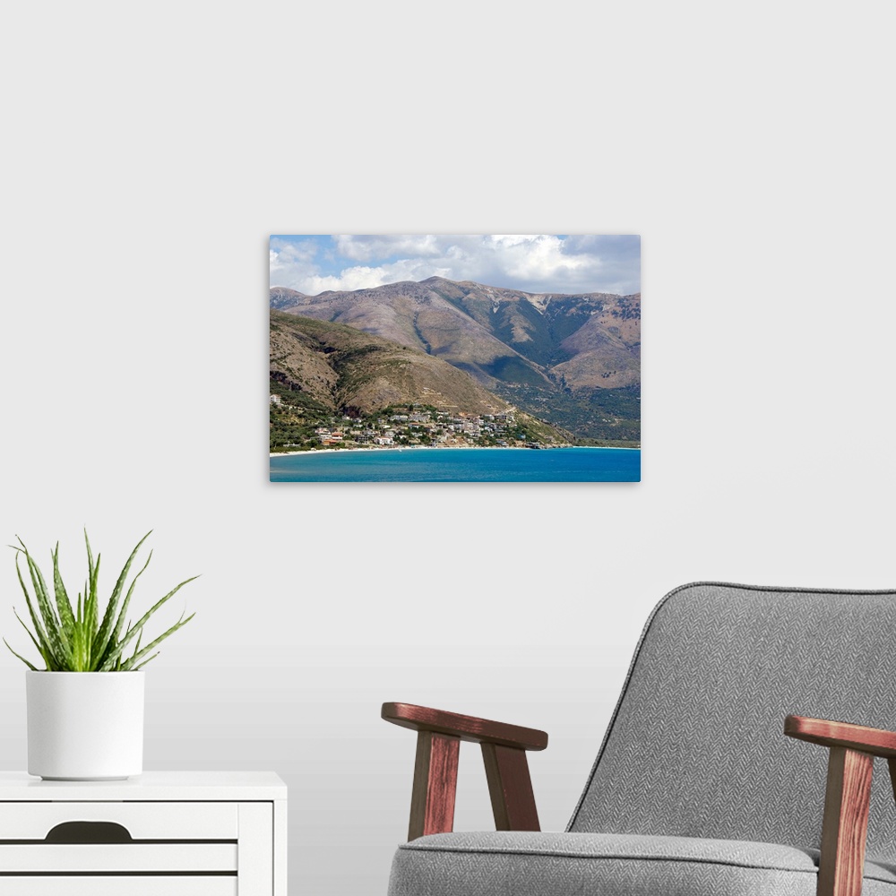 A modern room featuring REPUBLIC OF ALBANIA. Qeparo beach with mountainous landscape in the background.