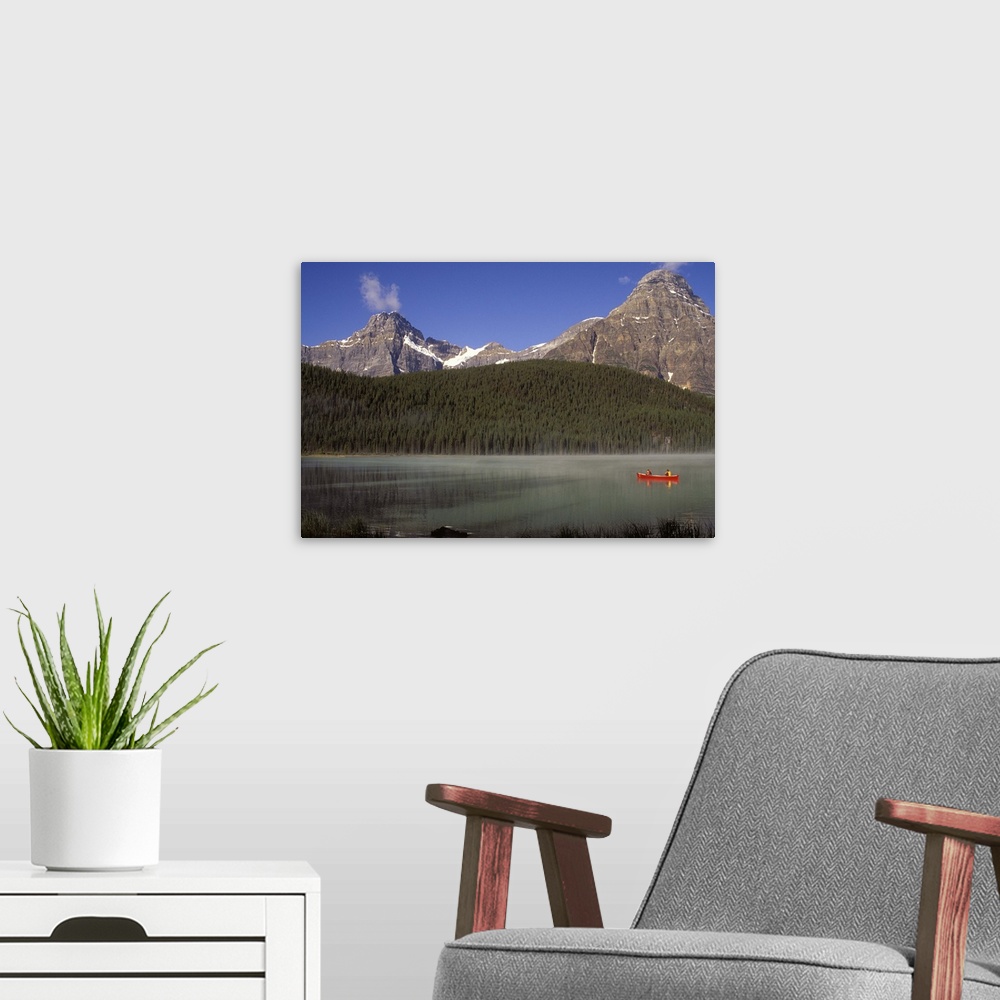 A modern room featuring Two boys fishing from a red canoe in Waterfowl Lake, in Canada's Banff national park.