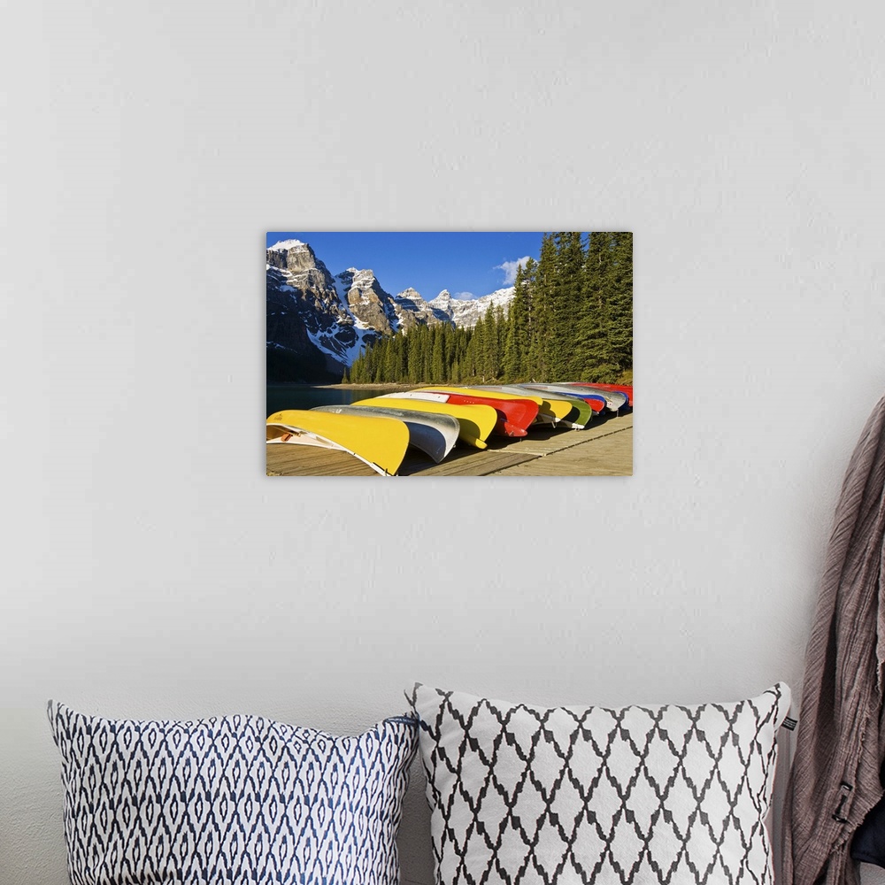 A bohemian room featuring North America, Canada, Alberta, Banff National Park, Moraine Lake and rental canoes stacked on shore