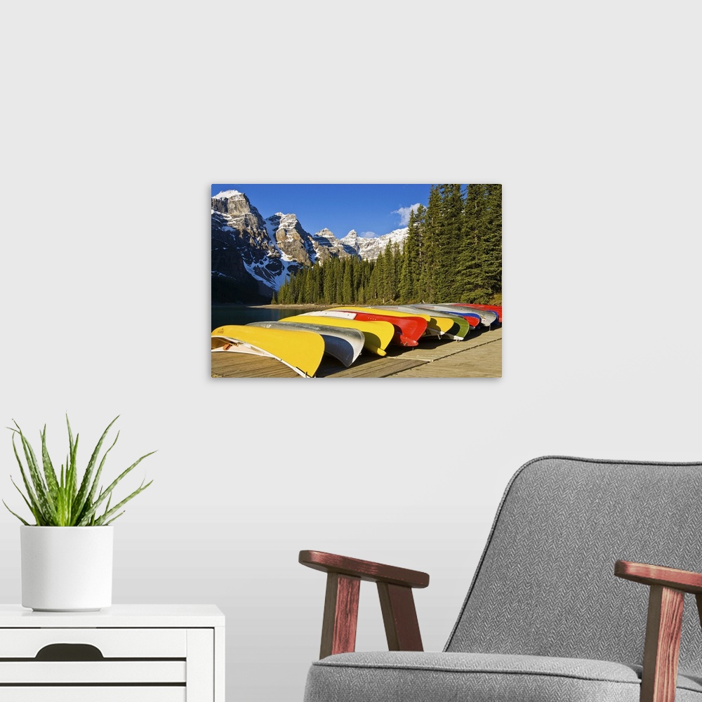 A modern room featuring North America, Canada, Alberta, Banff National Park, Moraine Lake and rental canoes stacked on shore