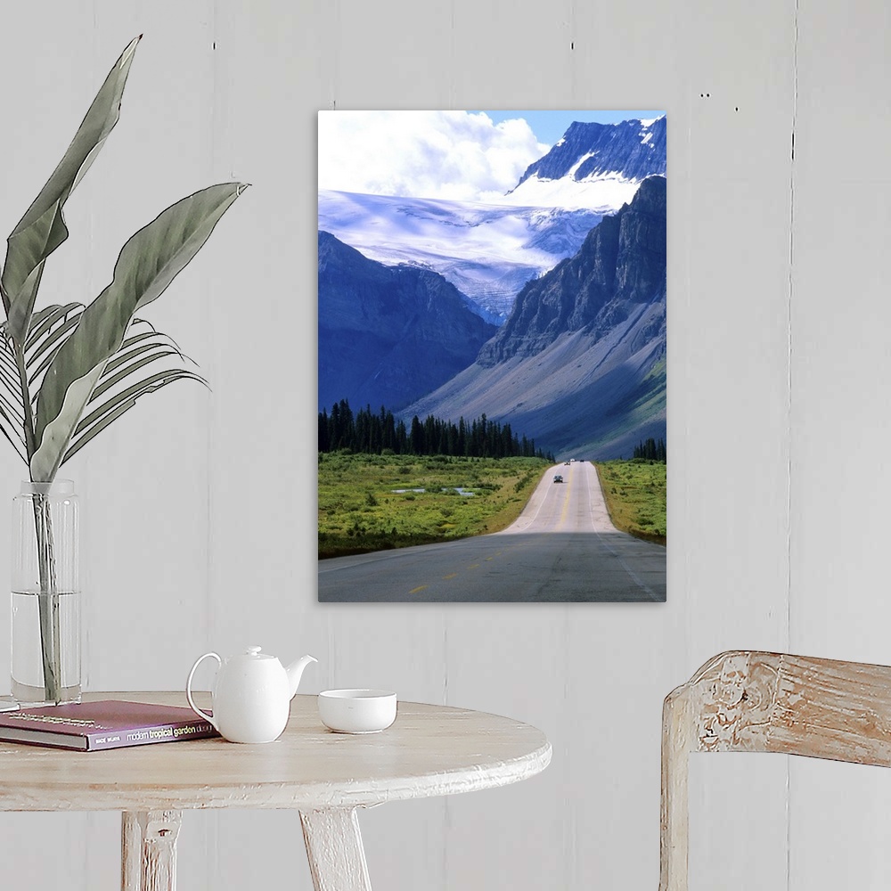 A farmhouse room featuring A road into the mountains of Banff National Park, where fierce clouds and snowcapped peaks loom i...