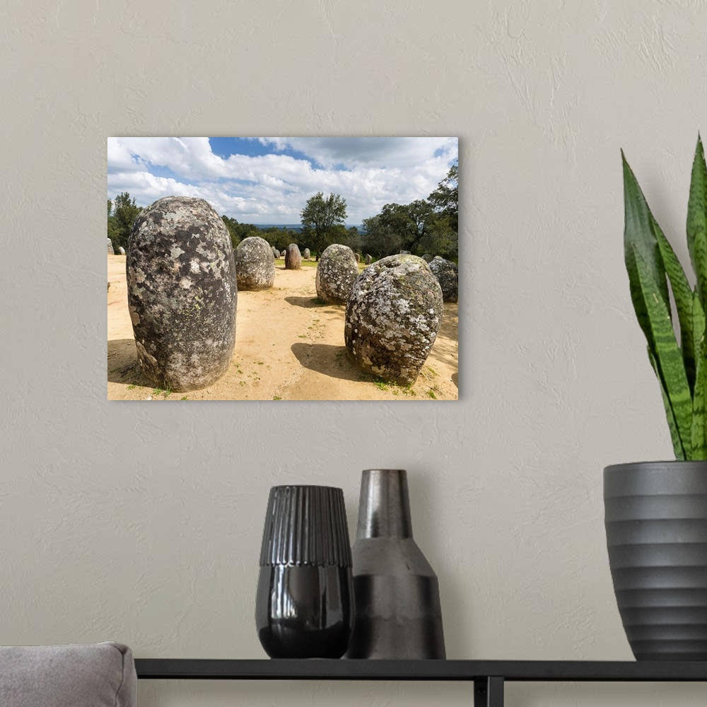 A modern room featuring Almendres Cromlech (Cromeleque dos Almendres), an oval stone circle dating back to the late neoli...