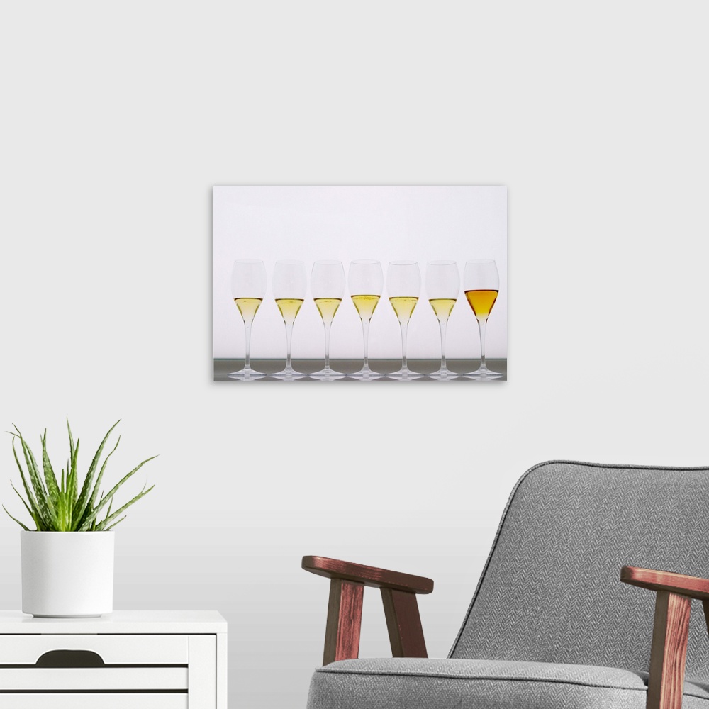 A modern room featuring Analytical wine tasting in a neutral white environment a white desk  a backlit white screen with ...