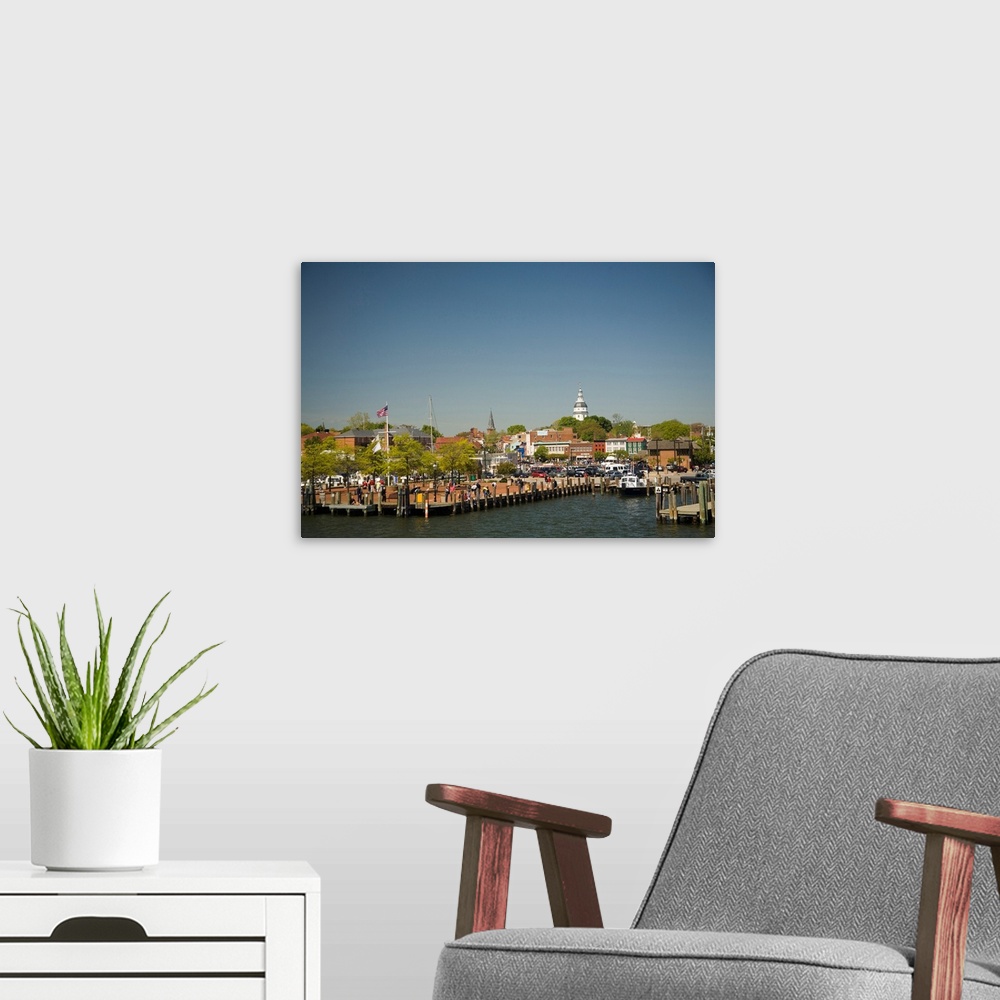 A modern room featuring Annapolis city docks, viewed from mouth of Severn River, historic State Capitol Building in dista...