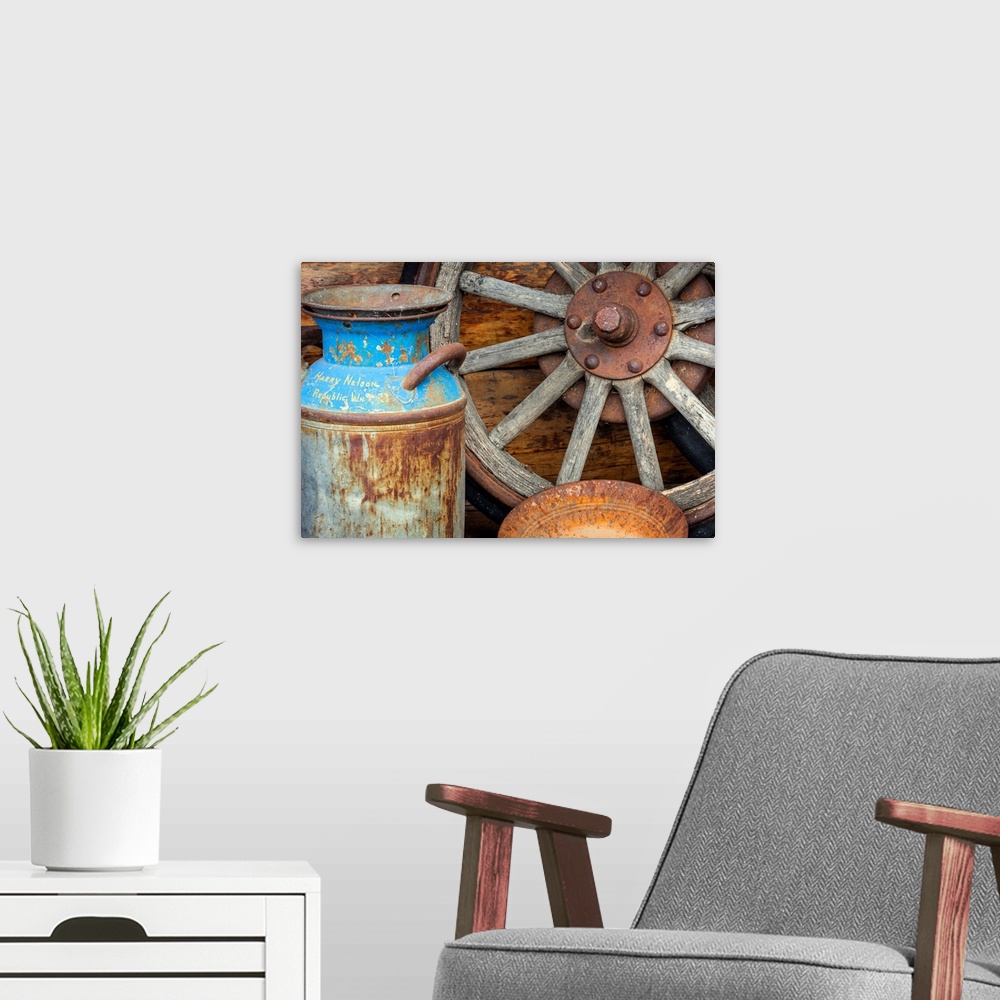 A modern room featuring USA, Alaska. Antique milk can, wagon wheel and gold pan.