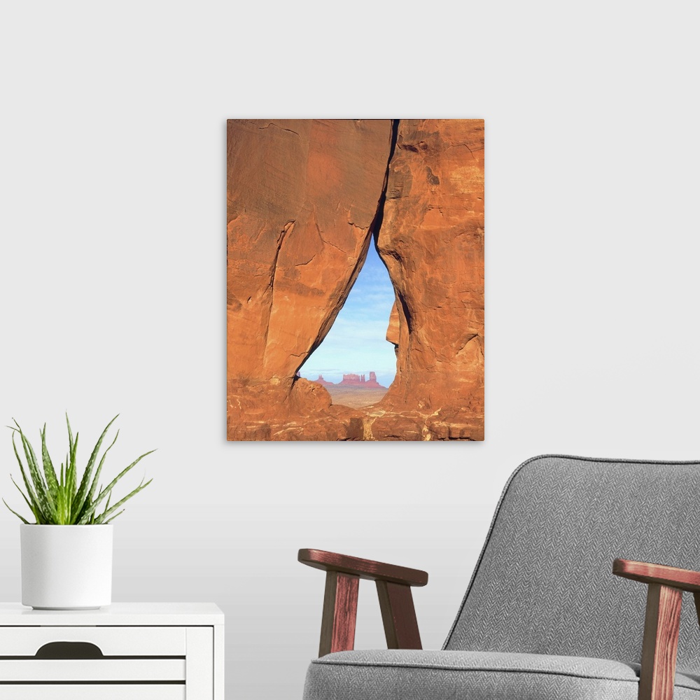 A modern room featuring USA, Arizona. View of formations through famous Teardrop Window through rock face in Monument Val...