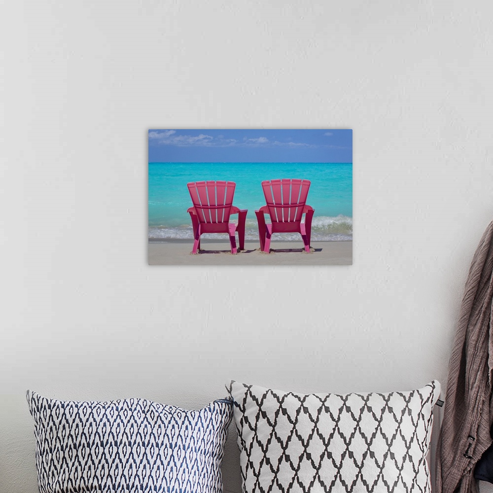 A bohemian room featuring Bahamas, Little Exuma Island. Pink chairs on beach.