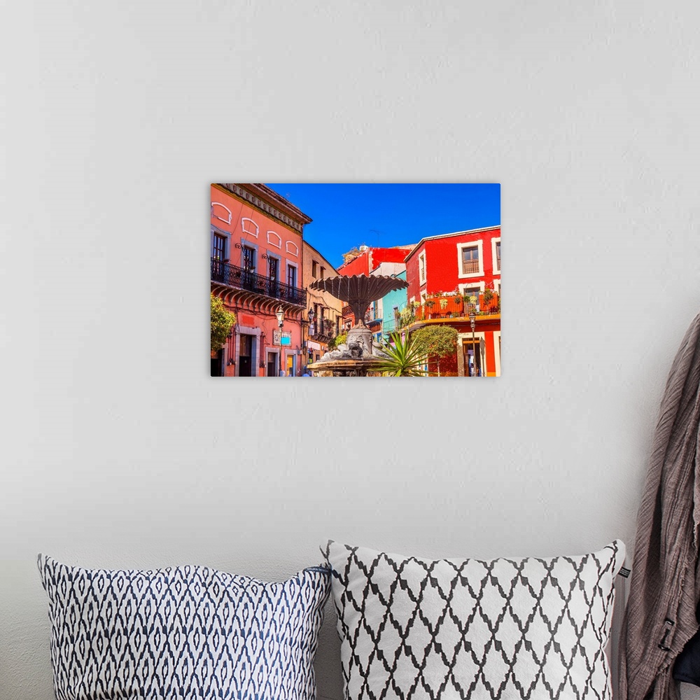A bohemian room featuring Plaza Del Baratillo, Baratillo Square, Fountain, colorful buildings, Guanajuato, Mexico .