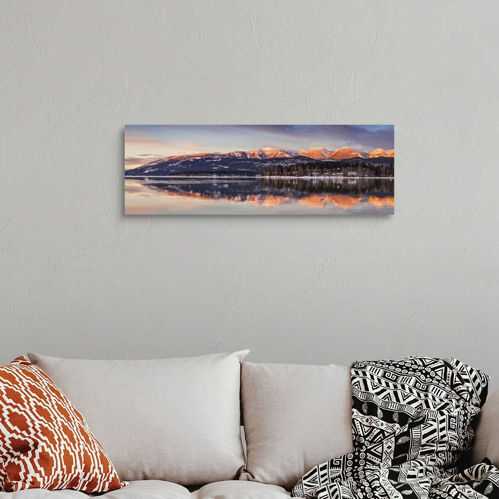 A bohemian room featuring Panoramic of Big Mountain reflects into Whitefish Lake at sunset in winter in Whitefish, Montana,...