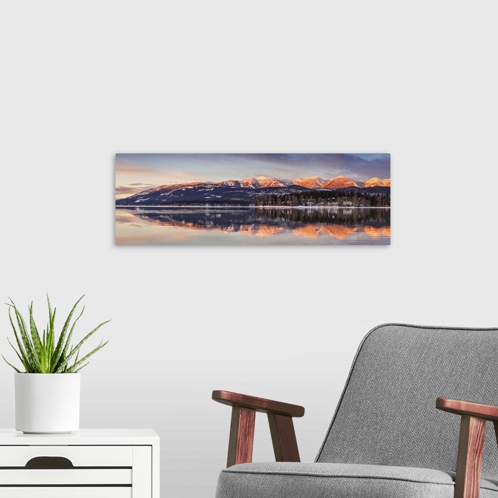 A modern room featuring Panoramic of Big Mountain reflects into Whitefish Lake at sunset in winter in Whitefish, Montana,...