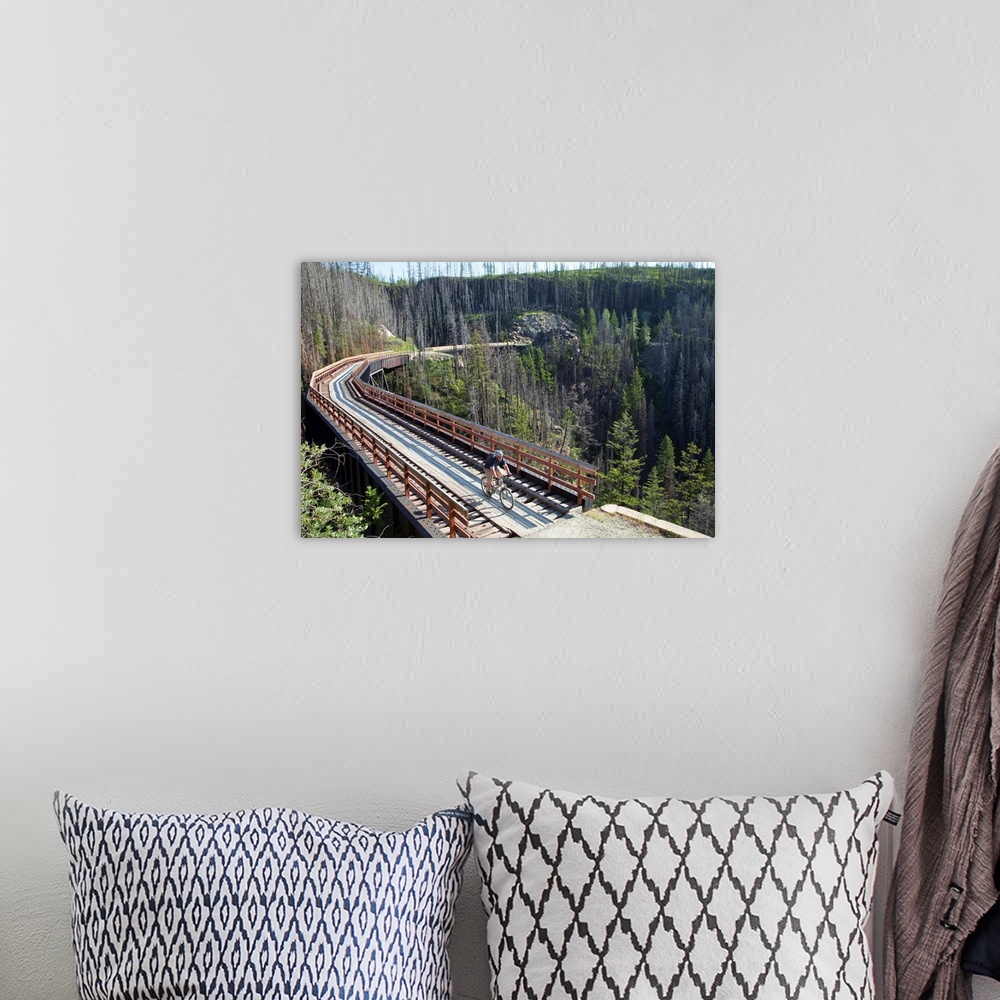 A bohemian room featuring Mike Deme rides across trestle in Myra Canyon on the Kettle Valley Railway bike path near Kelowna...