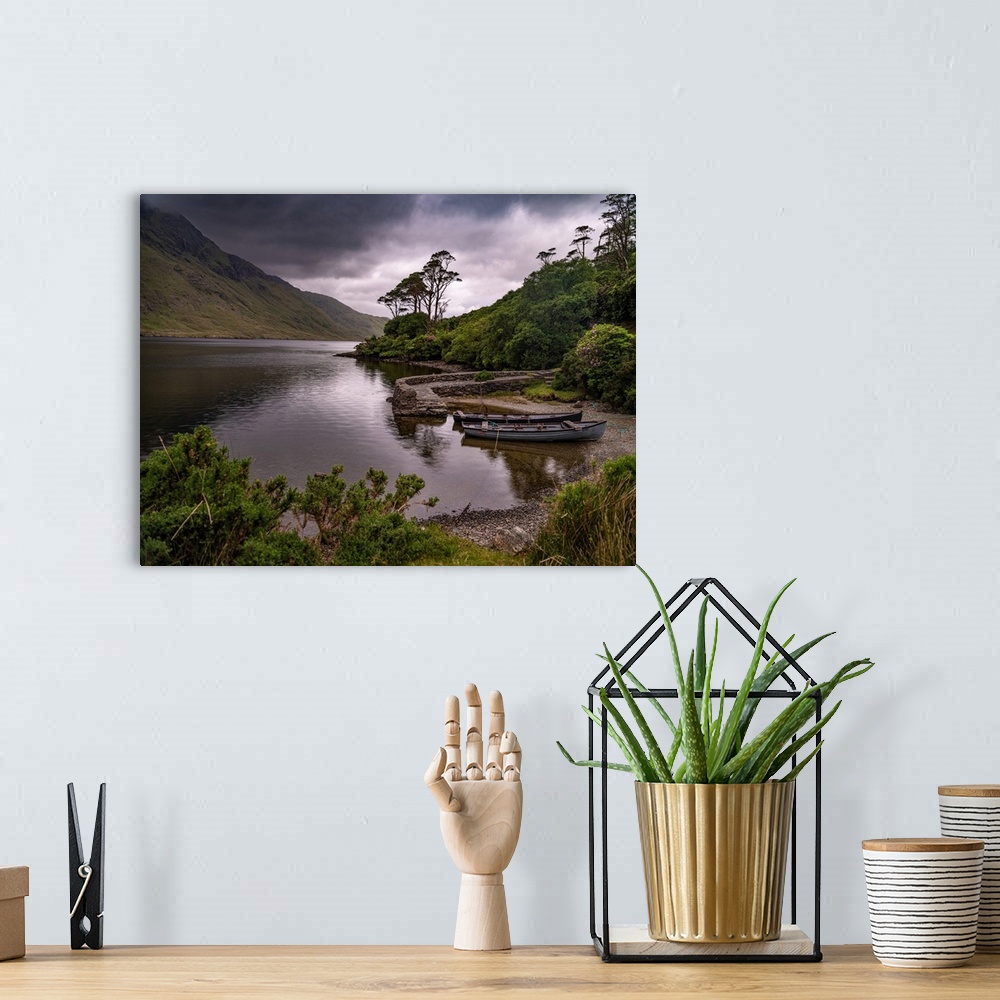 A bohemian room featuring Boats wait for passengers at Doo Lough, part of a national park in County Mayo, Ireland.