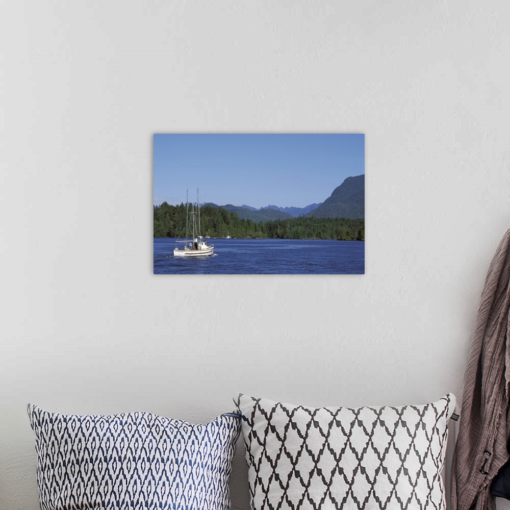 A bohemian room featuring Canada, British Columbia, Vancouver Island.Fishing boat from Tofino harbor into Clayoquot Sound